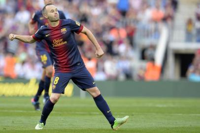 Barcelonas midfielder Andres Iniesta celebrates after scoring during the Spanish league football match FC Barcelona vs Malaga CF at the Camp Nou stadium in Barcelona on June 1, 2013.   AFP PHOTO/ LLUIS GENE