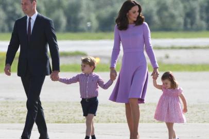 (FILES) This file photo taken on July 21, 2017 shows Britains Prince William, Duke of Cambridge and his wife Kate, the Duchess of Cambridge, and their children Prince George and Princess Charlotte on the tarmac of the Airbus compound in Hamburg, northern Germany.Prince William and his wife Kate are expecting their third child, Kensington Palace announced on September 4, 2017, adding that she would not be attending a planned engagement due to a severe form of morning sickness. /  / 