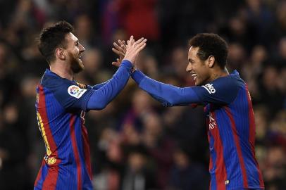 Barcelona's Argentinian forward Lionel Messi (L) celebrates with Barcelona's Brazilian forward Neymar (R) after scoring a goal during the Spanish league football match FC Barcelona vs RC Celta de Vigo at the Camp Nou stadium in Barcelona on March 4, 2017. / AFP PHOTO / LLUIS GENE