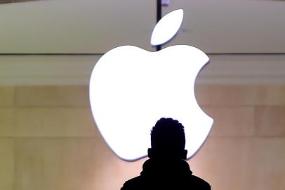 A man walks up the stairs at the Apple Store in Grand Central Station February 25, 2016. Apple has been in a legal fight with the government in the San Bernardino case, where the FBI wants the company to help hacking the iPhone of Syed Farook, a US citizen, who gunned down 14 people with his Pakistani wife Tashfeen Malik in the California city in December.Timothy A. CLARY / AFP