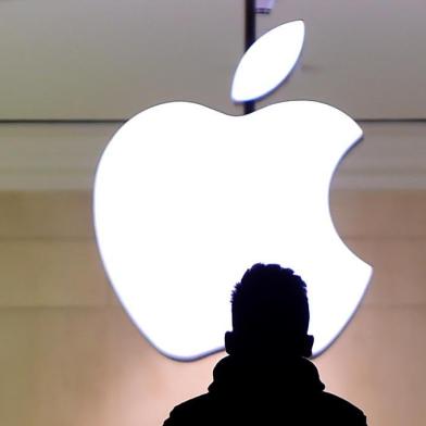 A man walks up the stairs at the Apple Store in Grand Central Station February 25, 2016. Apple has been in a legal fight with the government in the San Bernardino case, where the FBI wants the company to help hacking the iPhone of Syed Farook, a US citizen, who gunned down 14 people with his Pakistani wife Tashfeen Malik in the California city in December.Timothy A. CLARY / AFP