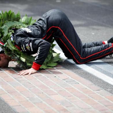 INDIANAPOLIS, IN - MAY 27: Will Power of Australia, driver of the #12 Verizon Team Penske Chevrolet celebrates by kissing the yard of bricks after winning the 102nd Running of the Indianapolis 500 at Indianapolis Motorspeedway on May 27, 2018 in Indianapolis, Indiana.   Chris Graythen/Getty Images/AFP