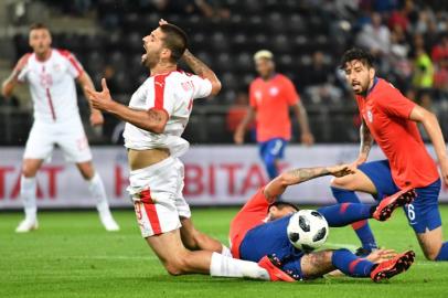 Serbia's Aleksandar Mitrovic falls down as he vies with Chile's Erick Pulgar during the international friendly footbal match Serbia vs Chile at the Merkur Arena in Graz, on June 4, 2018.  JOE KLAMAR / AFP