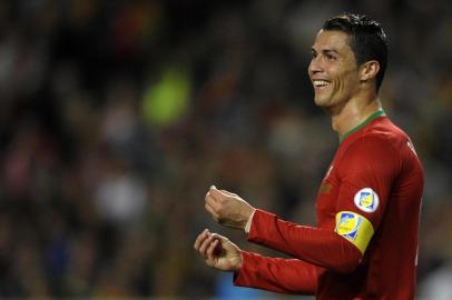 Portugal forward and captain Cristiano Ronaldo smiles during the FIFA 2014 World Cup qualifier play-off first leg football match Portugal vs Sweden at the Luz stadium in Lisbon on November 15, 2013.  Portugal won 1-0.  AFP PHOTO/ MIGUEL RIOPA