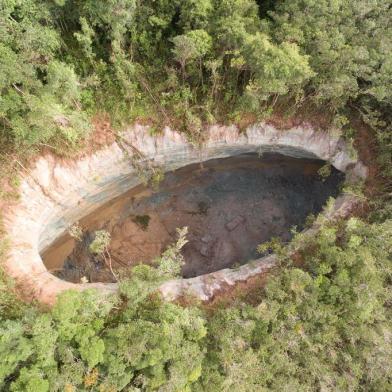 A imagem aérea de uma cratera que se abriu em Matarandiba, na Bahia, impressiona. São 69 metros de comprimento por 29 metros de largura, o que equivale a um terço de um campo de futebol com profundidade de 46 metros. A região fica a cerca de 1 km de uma vila de Vera Cruz, na Ilha de Itaparica e tem sido motivo de preocupação por parte dos moradores. 