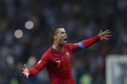  (FILES) In this file photo taken on June 15, 2018 Portugals forward Cristiano Ronaldo celebrates scoring his hat-trick during the Russia 2018 World Cup Group B football match between Portugal and Spain at the Fisht Stadium in Sochi .Hat-trick hero Cristiano Ronaldos sensational free-kick two minutes from time earned Portugal a 3-3 draw with Spain in a pulsating World Cup Group B encounter on Friday / AFP PHOTO / Adrian DENNIS / RESTRICTED TO EDITORIAL USE - NO MOBILE PUSH ALERTS/DOWNLOADSEditoria: SPOLocal: SochiIndexador: ADRIAN DENNISSecao: soccerFonte: AFPFotógrafo: STF