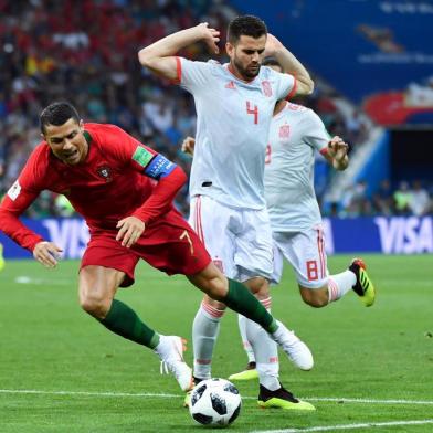 Portugals forward Cristiano Ronaldo falls down after being tackled by Spains defender Nacho Fernandez (R) during the Russia 2018 World Cup Group B football match between Portugal and Spain at the Fisht Stadium in Sochi on June 15, 2018. / AFP PHOTO / Nelson Almeida / RESTRICTED TO EDITORIAL USE - NO MOBILE PUSH ALERTS/DOWNLOADS