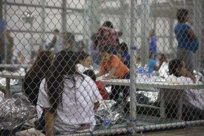 This US Customs and Border Protection photo obtained June 18, 2018 shows intake of illegal border crossers by US Border Patrol agents at the Central Processing Center in McAllen, Texas on May 23, 2018. / AFP PHOTO / US Customs and Border Protection / Handout / RESTRICTED TO EDITORIAL USE - MANDATORY CREDIT "AFP PHOTO / US CUSTOMS AND BORDER PROTECTION/HANDOUT" - NO MARKETING NO ADVERTISING CAMPAIGNS - DISTRIBUTED AS A SERVICE TO CLIENTS