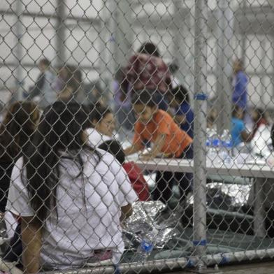 This US Customs and Border Protection photo obtained June 18, 2018 shows intake of illegal border crossers by US Border Patrol agents at the Central Processing Center in McAllen, Texas on May 23, 2018. / AFP PHOTO / US Customs and Border Protection / Handout / RESTRICTED TO EDITORIAL USE - MANDATORY CREDIT "AFP PHOTO / US CUSTOMS AND BORDER PROTECTION/HANDOUT" - NO MARKETING NO ADVERTISING CAMPAIGNS - DISTRIBUTED AS A SERVICE TO CLIENTS