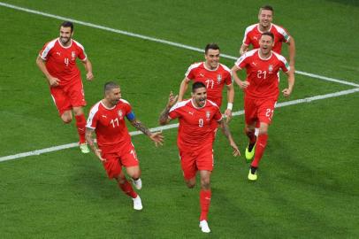 Serbia's forward Aleksandar Mitrovic (C) celebrates with teammate after scoring the opening goal during the Russia 2018 World Cup Group E football match between Serbia and Switzerland at the Kaliningrad Stadium in Kaliningrad on June 22, 2018.  Patrick HERTZOG / AFP