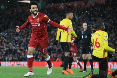 Liverpools Egyptian midfielder Mohamed Salah celebrates scoring the teams fourth goal during the English Premier League football match between Liverpool and Watford at Anfield in Liverpool, north west England on March 17, 2018. / AFP PHOTO / Lindsey PARNABY / RESTRICTED TO EDITORIAL USE. No use with unauthorized audio, video, data, fixture lists, club/league logos or live services. Online in-match use limited to 75 images, no video emulation. No use in betting, games or single club/league/player publications.  / 