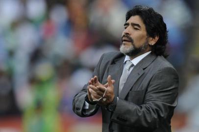 Argentinas coach Diego Maradona claps to his team during their Group B first round 2010 World Cup football match on June 12, 2010 at Ellis Park stadium in Johannesburg. NO PUSH TO MOBILE / MOBILE USE SOLELY WITHIN EDITORIAL ARTICLE - AFP PHOTO / DANIEL GARCIA