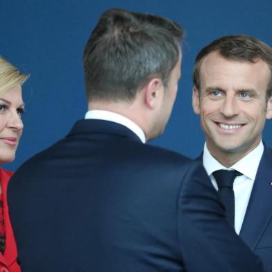 France's President Emmanuel Macron (2nd R), US President Donald Trump (R) and Croatia President Kolinda Grabar-Kitarovic arrive for the NATO (North Atlantic Treaty Organization) summit, at the NATO headquarters in Brussels, on July 11, 2018.  / AFP PHOTO / POOL / Tatyana ZENKOVICH