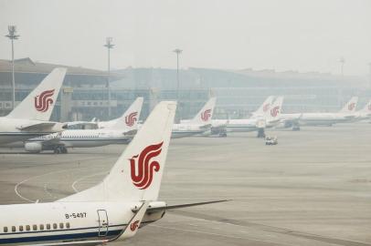 (FILES) This file photo taken on April 6, 2017 shows Air China planes parked at the Beijing Capital International Airport.An Air China jet made a rapid emergency descent after a co-pilot mistakenly turned off air-conditioning systems in a bid to conceal his e-cigarette smoke, Chinese media quoted the countrys civil aviation authority as saying on July 13, 2018. / AFP PHOTO / WANG ZHAO