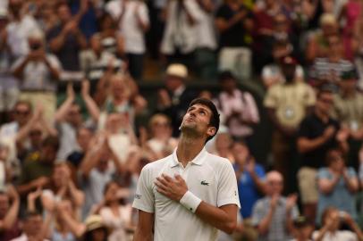 Serbias Novak Djokovic reacts after winning against Spains Rafael Nadal during the continuation of their mens singles semi-final match on the twelfth day of the 2018 Wimbledon Championships at The All England Lawn Tennis Club in Wimbledon, southwest London, on July 14, 2018.Djokovic won the match 6-4, 3-6, 7-6, 3-6, 10-8. / AFP PHOTO / Oli SCARFF / RESTRICTED TO EDITORIAL USE