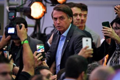 Federal deputy Jair Bolsonaro is surrounded by supporters as he launches his campaign for the Brazilian presidency for Octobers national election, in Rio de Janeiro, Brazil, on July 22, 2018.Controversial extreme-right candidate Jair Bolsonaro is expected to formalize his candidacy on Sunday and officially become the Social Liberal Party (PSL) candidate for Brazils October presidential elections, boosted by strong social media support and polls that show him headed to a second round. / AFP PHOTO / Carl DE SOUZA