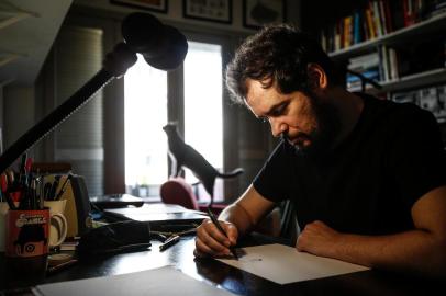  PORTO ALEGRE, RS, BRASIL - 2018.07.18 - Rafael Corrêa é um cartunista premiado internacionalmente e passa por uma situação delicada: tem esclerose múltipla, que afeta parte de seus movimentos. Rafael era canhoto e teve que aprender a desenhar com a mão direita. (Foto: ANDRÉ ÁVILA/ Agência RBS)Indexador: Andre Avila