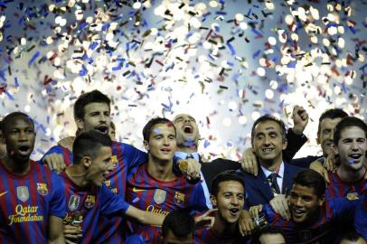 Barcelonas coach Josep Guardiola (C) celebrates his teams victory over Athletic Bilbao during their Spanish Kings Cup final football match at the Vicente Calderon stadium, in Madrid, on May 25, 2012.  Barcelona defeated Athletic Bilbao 3-0.  AFP PHOTO/ RAFA RIVAS