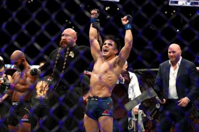 LOS ANGELES, CA - AUGUST 04: Henry Cejudo celebrates his UFC Flyweight Title Bout win over Demetrious Johnson during UFC 227 at Staples Center on August 4, 2018 in Los Angeles, United States.   Joe Scarnici/Getty Images/AFP