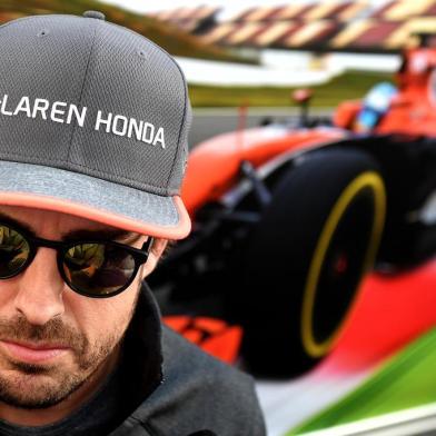 (FILES) In this file photo taken on April 27, 2017 McLarens Spanish driver Fernando Alonso answers journalists questions in the paddock at the Sochi Autodrom circuit in Sochi on April 27, 2017.Fernando Alonso will retire from Formula 1 at the end of the season McLaren announced on August 14, 2018. / AFP PHOTO / ANDREJ ISAKOVIC