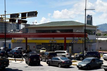 Drivers queue at a gas station in Caracas where people are making lines for petrol on August 17, 2018 for the uncertainty about the price and availability of gasoline from Monday on, when the new currency with five fewer zeros starts circulating in Venezuela. President Nicolas Maduro announced on August 13 that Venezuelas dirt-cheap fuel will be available only to people with a special government aid card that the opposition has denounced as a tool for controlling people. People who want to keep benefiting from subsidized gas prices in this oil-rich nation must register their vehicles by Friday using the so-called carnet de la patria, or fatherland card, which provides access to government assistance. / AFP PHOTO / Federico PARRA