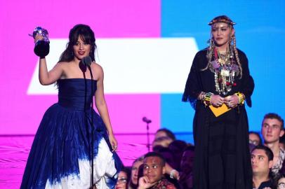 NEW YORK, NY - AUGUST 20: Camila Cabello accepts an award from Madonna onstage during the 2018 MTV Video Music Awards at Radio City Music Hall on August 20, 2018 in New York City.   Theo Wargo/Getty Images/AFP