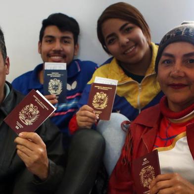 Venezuelan migrants wait to enter the boarding area of the international airport in Lima after a group of Venezuelan nationals who chose to return to their country after experiencing difficulties in Peru received a plane ticket paid by their government, on August 27, 2018. In contrast to the avalanche of Venezuelans who overflowed the Peruvian border in recent weeks fleeing the crisis in their country, 97 travellers, including 22 children, were happy to board the plane to return to their homeland, despite being plunged into an acute political and economic crisis. / AFP PHOTO / Teo BIZCA