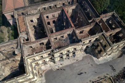 Aerial view of Rio de Janeiros treasured National Museum, one of Brazils oldest, on September 3, 2018, a day after a massive fire ripped through the building. The majestic edifice stood engulfed in flames as plumes of smoke shot into the night sky, while firefighters battled to control the blaze that erupted around 2230 GMT. Five hours later they had managed to smother much of the inferno that had torn through hundreds of rooms, but were still working to extinguish it completely. / AFP PHOTO / Mauro Pimentel