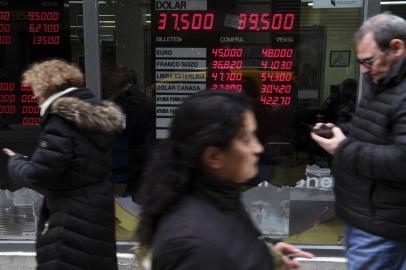 Currency exchange values are displayed in the buy-sell board of a bureau de exchange in Buenos Aires, on August 31, 2018. Argentinas peso began to recover on Friday as markets opened, making a tiny 0.68 percent gain after losing 20 percent of its value against the dollar over the previous two days. / AFP PHOTO / EITAN ABRAMOVICH