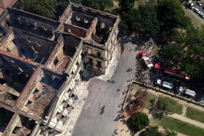 Aerial view of Rio de Janeiros treasured National Museum, one of Brazils oldest, on September 3, 2018, a day after a massive fire ripped through the building. The majestic edifice stood engulfed in flames as plumes of smoke shot into the night sky, while firefighters battled to control the blaze that erupted around 2230 GMT. Five hours later they had managed to smother much of the inferno that had torn through hundreds of rooms, but were still working to extinguish it completely. / AFP PHOTO / Mauro Pimentel