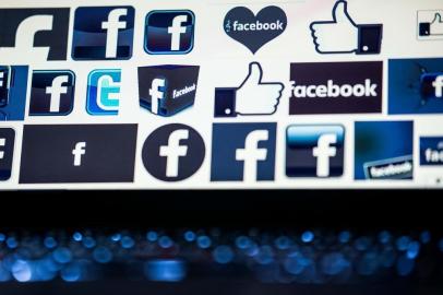 (FILES) A file photo taken on March 23, 2018 shows Facebook logos on a computer screen in Beijing.A large number of Americans are stepping back from Facebook in the wake of recent scandals over the social network's handling of private user data, a study showed September 5, 2018. The Pew Research Center report found 42 percent of US Facebook users said they had "taken a break" from the platform in the past 12 months, and 26 percent said they had deleted the Facebook app from their phone.Among those in the 18-29 age group, the break with Facebook appeared more pronounced, with 44 percent claiming to have deleted the Facebook mobile app. / AFP PHOTO / NICOLAS ASFOURI