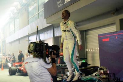 Mercedes British driver Lewis Hamilton celebrates after winning the Singapore Formula One Grand Prix at the Marina Bay Street Circuit in Singapore on September 16, 2018.  / AFP PHOTO / Roslan RAHMAN