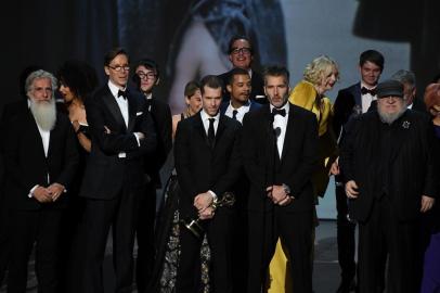 Writer-producers D.B. Weiss (C-L), David Benioff (C-R) and the cast of Game of Thrones accept the award Outstanding Drama series  onstage during the 70th Emmy Awards at the Microsoft Theatre in Los Angeles, California on September 17, 2018. / AFP PHOTO / Robyn Beck