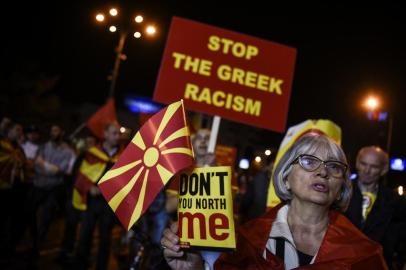 Supporters of a boycott for the name-change referendum celebrate in front of the Parliament in Skopje on September 30, 2018, as the vote was marred by a low turnout, with only a third of the electorate voting.The vast majority of voters supported the plan to rename the country and thereby end a decades-long spat with Greece, partial results showed. With ballots from 43 percent of polling stations counted, 90.72 percent of votes were in favour of the name changing to North Macedonia, compared to 6.26 percent opposing the move, according to the electoral commissions official count. / AFP PHOTO / Armend NIMANI