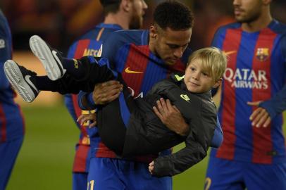 Barcelonas Brazilian forward Neymar jokes with his son Davi Lucca before the Spanish Copa del Rey (Kings Cup) round of 16 second leg football match FC Barcelona vs Athletic Club de Bilbao at the Camp Nou stadium in Barcelona on January 11, 2017. / AFP PHOTO / LLUIS GENE