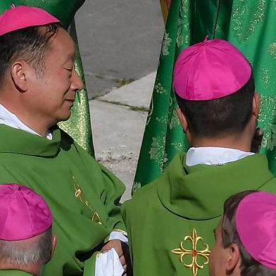 Chinese Bishop Yang Xiaoting (L) attends a Papal mass for the opening of the Synod of Bishops, focusing on Young People, the Faith and Vocational Discernment, on October 3, 2018 at St. Peters square in the Vatican.   / AFP PHOTO / Tiziana FABI