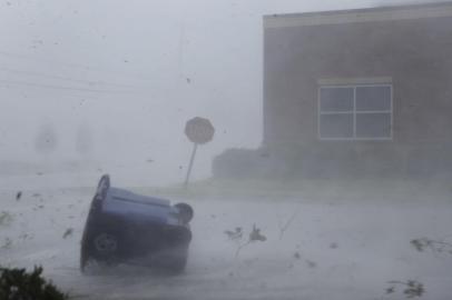 PANAMA CITY, FL - OCTOBER 10: A trash can and debris are blown down a street by Hurricane Michael on October 10, 2018 in Panama City, Florida. The hurricane made landfall on the Florida Panhandle as a category 4 storm.   Joe Raedle/Getty Images/AFP