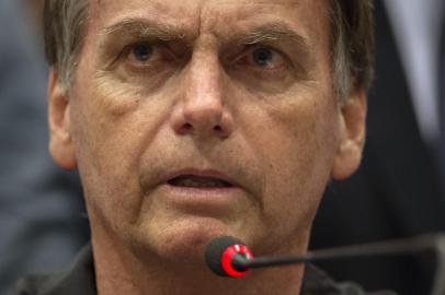 Brazil's right-wing presidential candidate for the Social Liberal Party (PSL) Jair Bolsonaro gestures during a press conference in Rio de Janeiro, Brazil on October 11, 2018. - The far-right frontrunner to be Brazil's next president, Jair Bolsonaro, stumbled Wednesday by spooking previously supportive investors, while a spate of violent incidents pointed to deep polarization caused by the election race. (Photo by Mauro Pimentel / AFP)