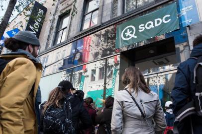 People line up outside a cannabis store to purchase products for the first time, October 17, 2018 in Montreal, Canada. - Nearly a century of marijuana prohibition came to an end Wednesday as Canada became the first major Western nation to legalize and regulate its sale and recreational use. Scores of customers braved the cold for hours outside Tweed, a pot boutique in St John's, Newfoundland that opened briefly at midnight, to buy their first grams of legal cannabis.In total, Statistics Canada says 5.4 million Canadians will buy cannabis from legal dispensaries in 2018 -- about 15 percent of the population. Around 4.9 million already smoke. (Photo by MARTIN OUELLET-DIOTTE / AFP)