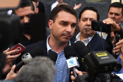 Brazilian Deputy for Rio de Janeiro Flavio Bolsonaro (C), son of Brazils right-wing presidential frontrunner Jair Bolsonaro, speaks to the press outside the Santa Casa hospital in the southeastern city of Juiz de Fora, Minas Gerais State, Brazil on September 7, 2018. Brazils right-wing presidential frontrunner Jair Bolsonaro was stabbed and seriously injured while campaigning on September 6, with police saying the suspect claimed to be acting on orders from God.  / AFP PHOTO / Fabio TEIXEIRA