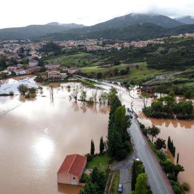 This aerial view shows the River Argens at Roquebrune-sur-Argens on November 1, 2018, after it burst its banks following heavy rainfall. - The Var region in the south of France remains on orange alert for floods, while the orange warning storm-rains-floods was raised for this department as well as for the Gard, Lozere and Bouches-du-Rhone, announced Météo France early November 1. (Photo by Yann COATSALIOU / AFP)