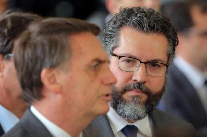 Brazilian President-elect Jair Bolsonaro (L) and his newly appointed Foreign Minister, Brazilian diplomat Ernesto Araujo, are pictured at the headquarters of the transitional government in Brasilia, on November 14, 2018. - Its the eighth ministerial appointment Bolsonaro has made since winning the presidential election at the end of last month. (Photo by Sergio LIMA / AFP)