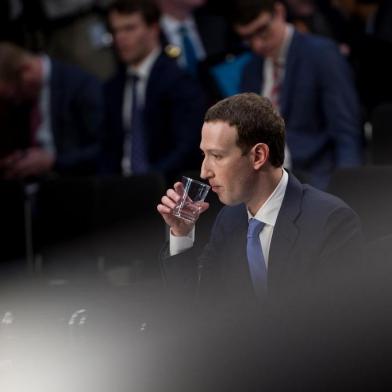 Facebook chief Zuckerberg testifies to lawmakers after data hijacking scandalFacebook CEO Mark Zuckerberg waits for a joint hearing of the Senate Commerce, Science and Transportation Committee and Senate Judiciary Committee on Capitol Hill April 10, 2018 in Washington, DC.Zuckerberg, making his first formal appearance at a Congressional hearing, seeks to allay widespread fears ignited by the leaking of private data on tens of millions of users to British firm Cambridge Analytica working on Donald Trumps 2016 presidential campaign. / AFP PHOTO / Brendan SmialowskiEditoria: FINLocal: WashingtonIndexador: BRENDAN SMIALOWSKISecao: electionFonte: AFPFotógrafo: STF