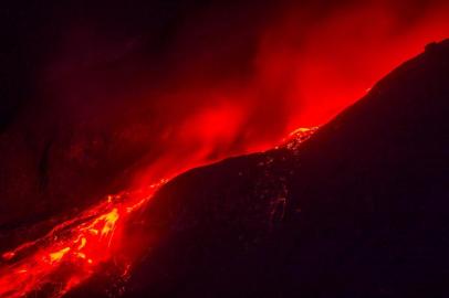 TOPSHOTSMolten lava from the Mount Sinabung volcano is seen from the nearest village in Karo district, North Sumatra province, on June 16, 2015. More than 1,200 Indonesian villagers were evacuated June 15 from their homes close to a rumbling volcano on Sumatra island, an official said. AFP PHOTO / Sutanta ADITYA