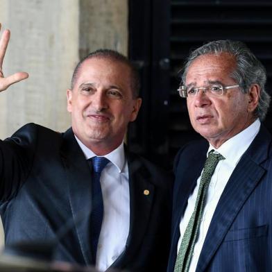 Onyx Lorenzoni (L), the future Chief of Staff of Brazilian president-elect Jair Bolsonaros government and Paulo Guedes, who was appointed as Finance Minister gesture uppon arrival at the transitional governments headquarters in Brasilia on November 21, 2018. (Photo by EVARISTO SA / AFP)