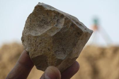 This handout image obtained November 29, 2018 shows an Oldowan core(stone tool) freshly excavated at Ain Boucherit from which sharp-edged cutting flakes were removed. - Archaeologists have discovered in Algeria cut stone tools dating back 2.4 million years, much older than those found in this region so far, which could challenge East Africa as a cradle unique of humanity, according to work published November 29, 2018 in the prestigious journal Science. Limestone pebbles and cut flints were discovered in Setif, 300 km east of Algiers, by a team of international researchers including Algerians. The tools looked exactly like Oldowan, found so far mainly in East Africa. (Photo by Mohamed SAHNOUNI / Mohamed Sahnouni / AFP) / RESTRICTED TO EDITORIAL USE - MANDATORY CREDIT AFP PHOTO / MOHAMED SAHNOUNI/HANDOUT - NO MARKETING NO ADVERTISING CAMPAIGNS - DISTRIBUTED AS A SERVICE TO CLIENTS