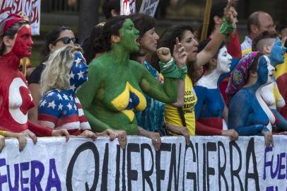 Body-painted activists shout slogans during a protest against the G20 Leaders Summit taking place in Buenos Aires, on November 30, 2018. - G20 leaders on Friday opened annual talks rent by the deepest divisions since their first summit 10 years ago, as US President Donald Trump came under fire and Saudi Arabias de facto ruler came in from the cold. (Photo by ALBERTO RAGGIO / AFP)