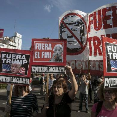 Activists take part in a protest against the G20 Leaders Summit taking place in Buenos Aires, on November 30, 2018. - G20 leaders on Friday opened annual talks rent by the deepest divisions since their first summit 10 years ago, as US President Donald Trump came under fire and Saudi Arabias de facto ruler came in from the cold. (Photo by ALBERTO RAGGIO / AFP)