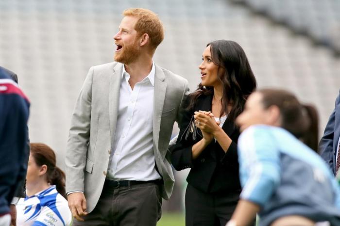 AFP / Britain's Prince Harry, Duke of Sussex (L) Britain's Meghan, Duchess of Sussex watch a dem