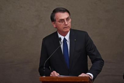 Brazilian President-elect Jair Bolsonaro delivers a speech after receiving from Electoral Supreme Court (TSE) president Justice Rosa Weber a diploma that certifies he can take office as president, during a ceremony at the TSE in Brasilia, on December 10, 2018. - Bolsonaro takes office on January 1, 2019. (Photo by EVARISTO SA / AFP)